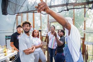 AgLaunch staff with a group of students in a greenhouse.