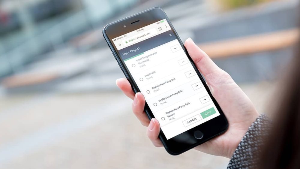 Hand holding phone with buildee app on screen