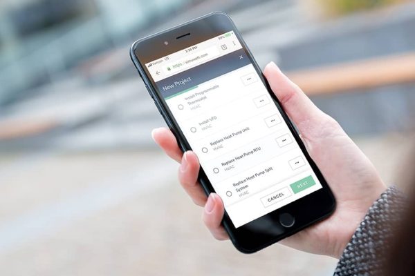 Hand holding phone with buildee app on screen