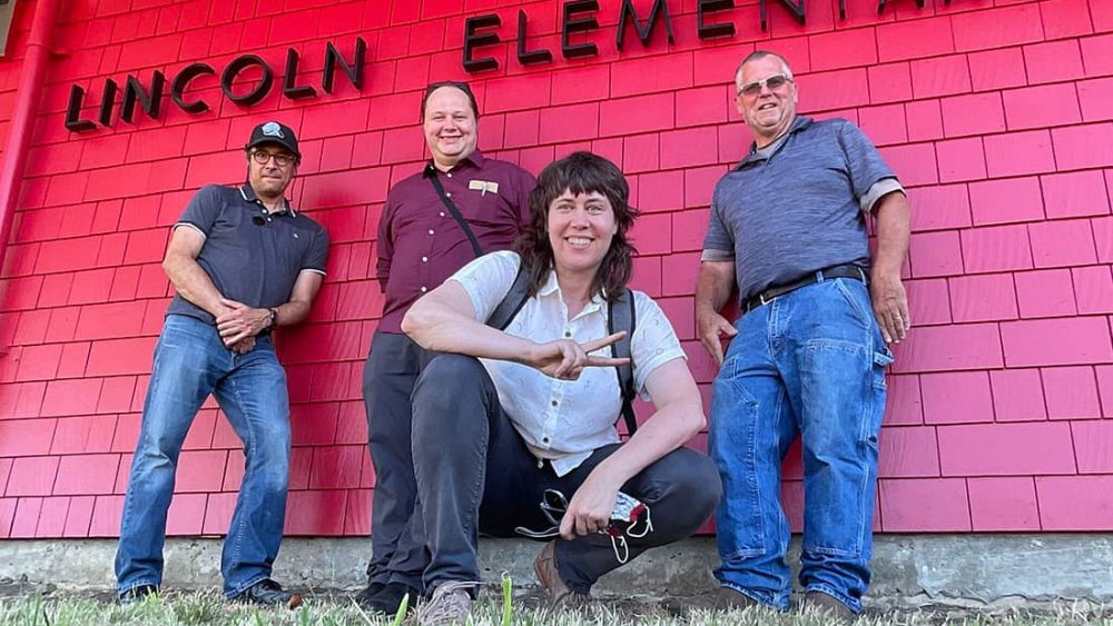 CEL team stands in front of building