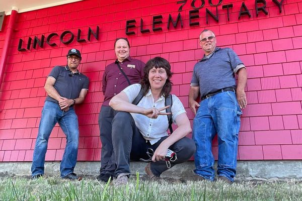CEL team stands in front of building