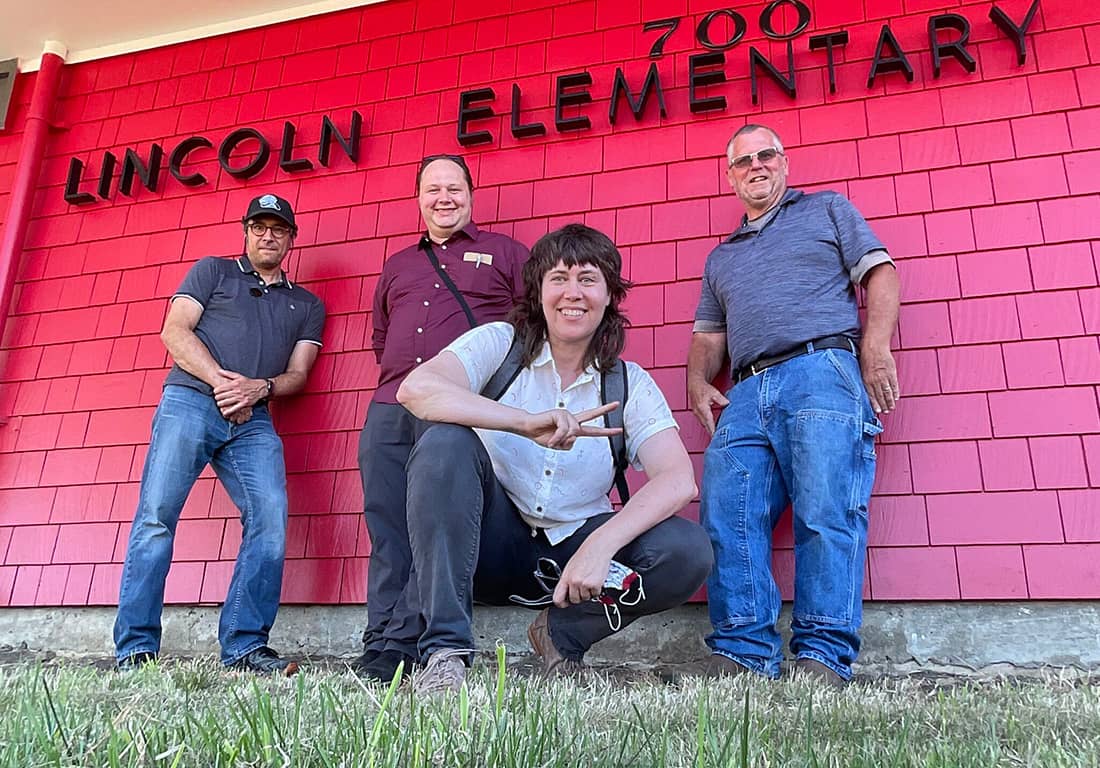 CEL team stands in front of building