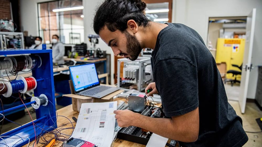 Man working with electronic components in a lab