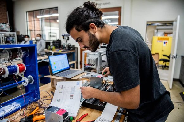 Man working with electronic components in a lab