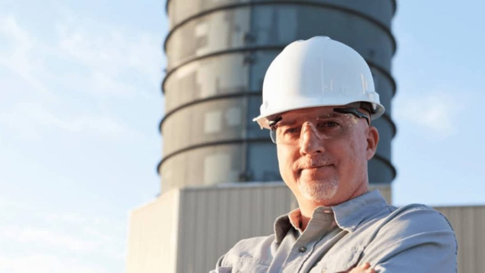 Man in hard hat poses for photo