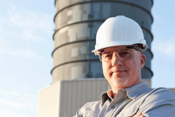 Man in hard hat poses for photo