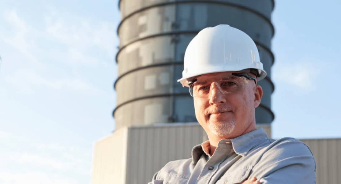 Man in hard hat poses for photo