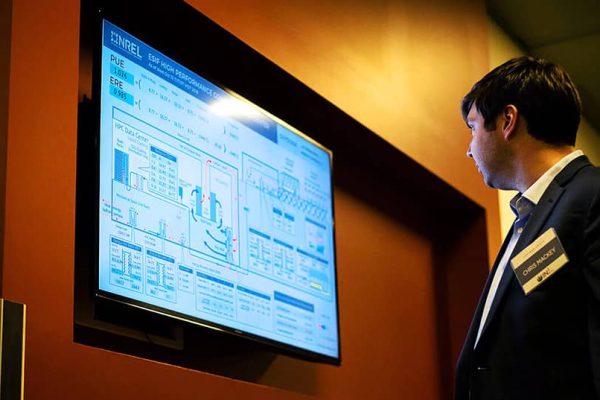 Chris Mackey, co-founder of Ladybug Tools, examines a diagram of NREL's energy management system.