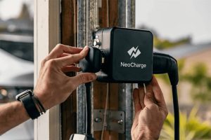Close up of person's hands installing NeoCharge smart splitter.