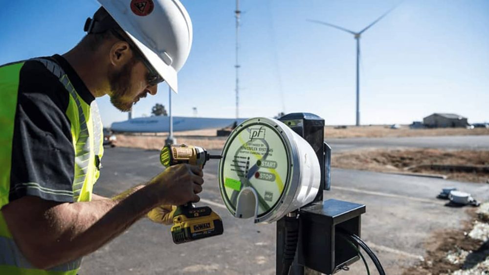 Technician works on charging station at NREL's Flatirons Campus.