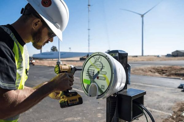 Technician works on charging station at NREL's Flatirons Campus.