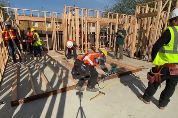 Workers build frame of home