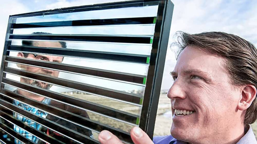 Researcher looks at glass panel