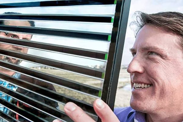 Researcher looks at glass panel