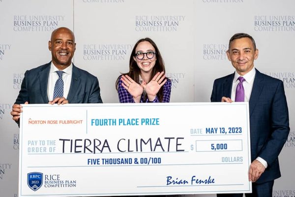 Three people holding a big check and smiling.