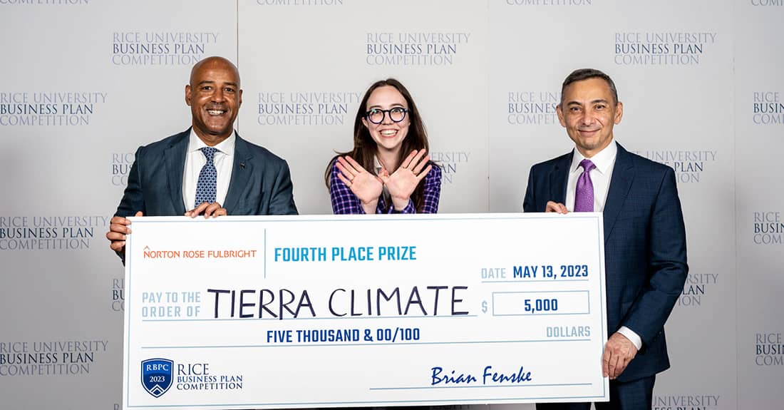 Three people holding a big check and smiling.