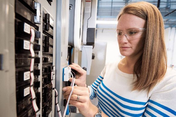 Bethany Sparn works on a new type of nonintrusive power meter at NREL.